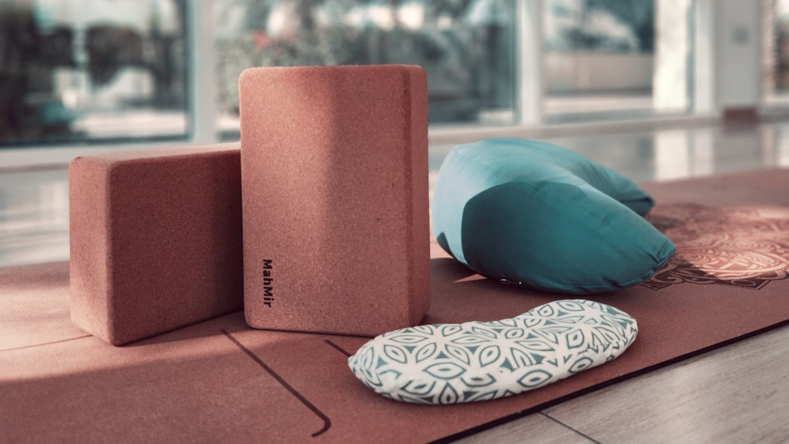 Yoga props setup – featuring yoga mats, blocks, straps, and bolsters neatly arranged in a yoga studio, ready for practice
